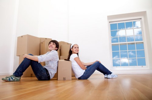 Moving team handling desks and IT items during an office relocation
